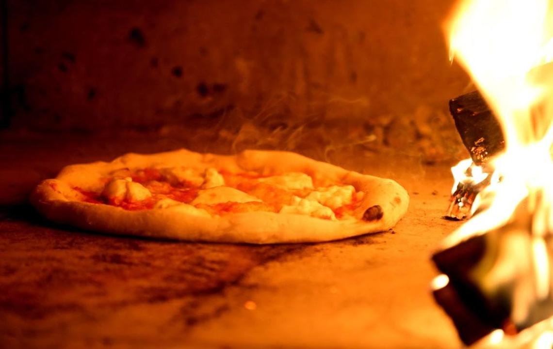 Napoli’s Neapolitan pizza is cooked in wood-fired oven in a food truck. 