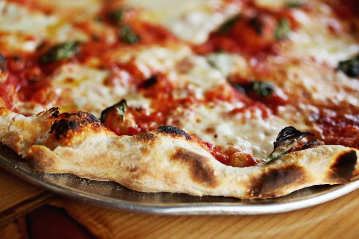 The gas-fired ovens at Pizzeria Mercato can crank out 700-plus degrees which produce an exemplary thin, blister-charred crust.