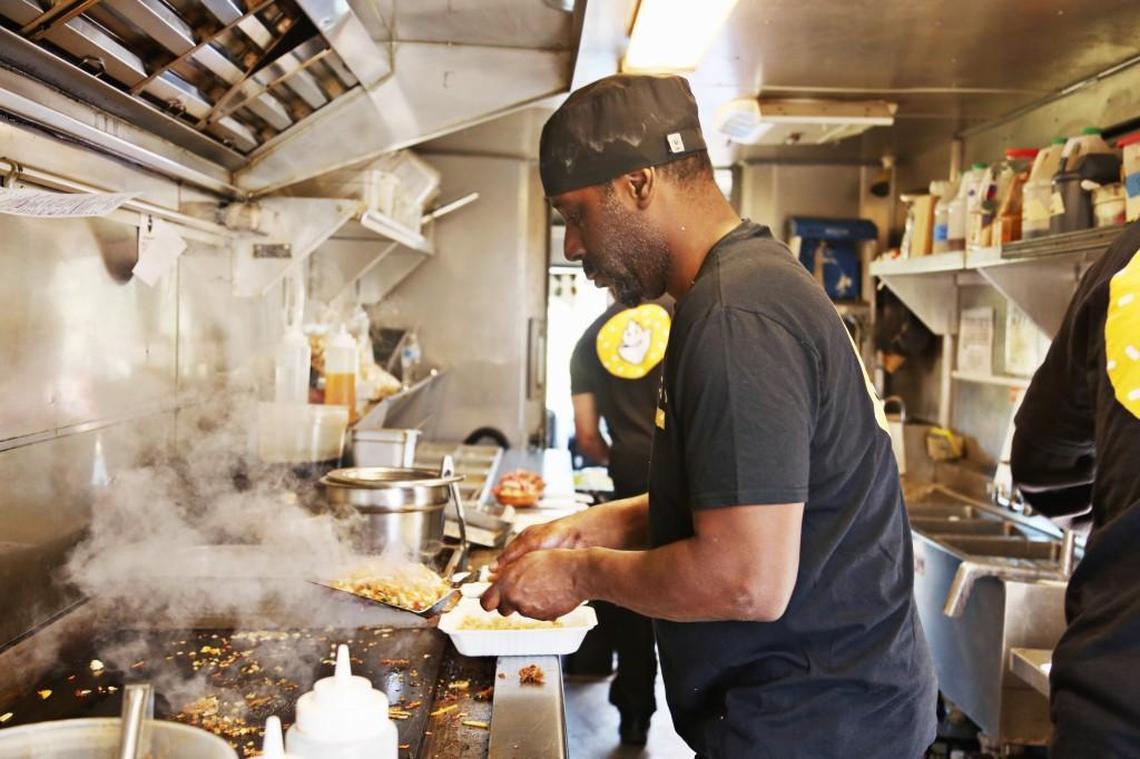 David Meredith prepares an order on the Mr. Mongolian food truck in Durham Wednesday, Jan. 24, 2018.