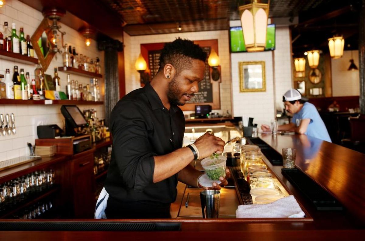 Viceroy bartender David Jackson mixes a drink for a customer April 10, 2017. The British Indian fusion restaurant has an eclectic menu of house cocktails that includes a Tamarind Margarita.