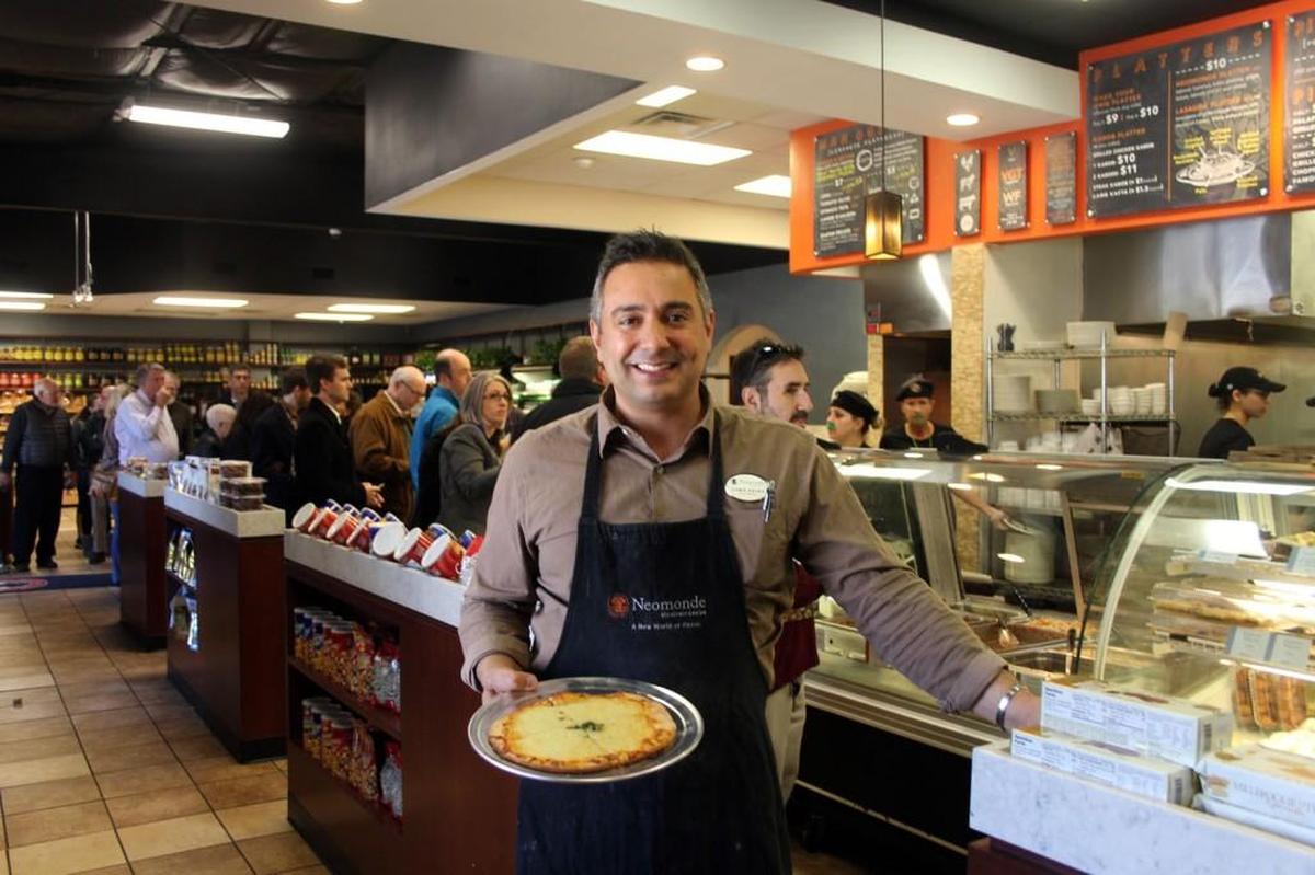 Christopher Saleh, vice president of retail and marketing of Neomonde Mediterranean Bakery and Deli, in the Raleigh location. He’s holding a new man’ousheh, or flatbread, that’s been added to the menu.