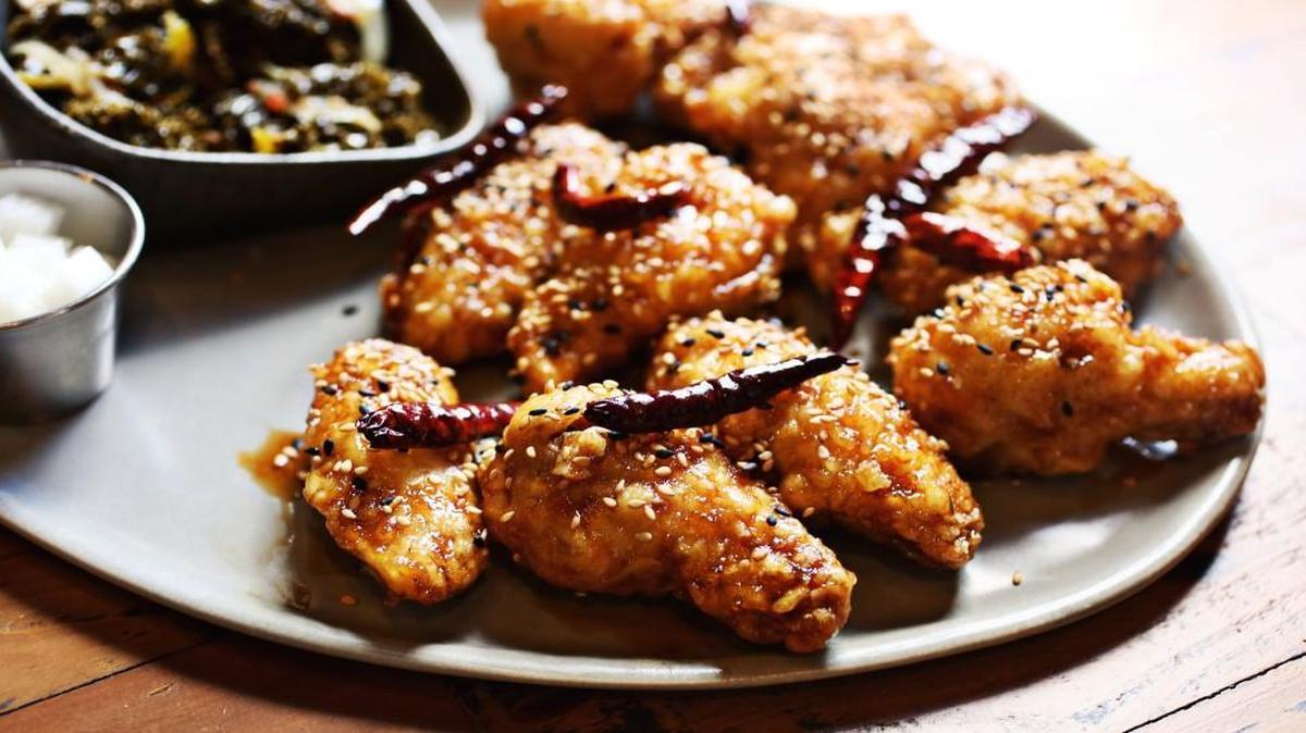 The house specialty at M Kokko is “KFC” wings, the K standing for Korean — as in that country’s famously extra-crispy twice-fried chicken. Twelve bucks gets you eight wings, glazed with a classic soy-garlic sauce or a spicy-sweet sauce riddled with freshly toasted red chiles. That price also gets you a small dish of house-pickled daikon and a seasonal vegetable side — sautéed kale.