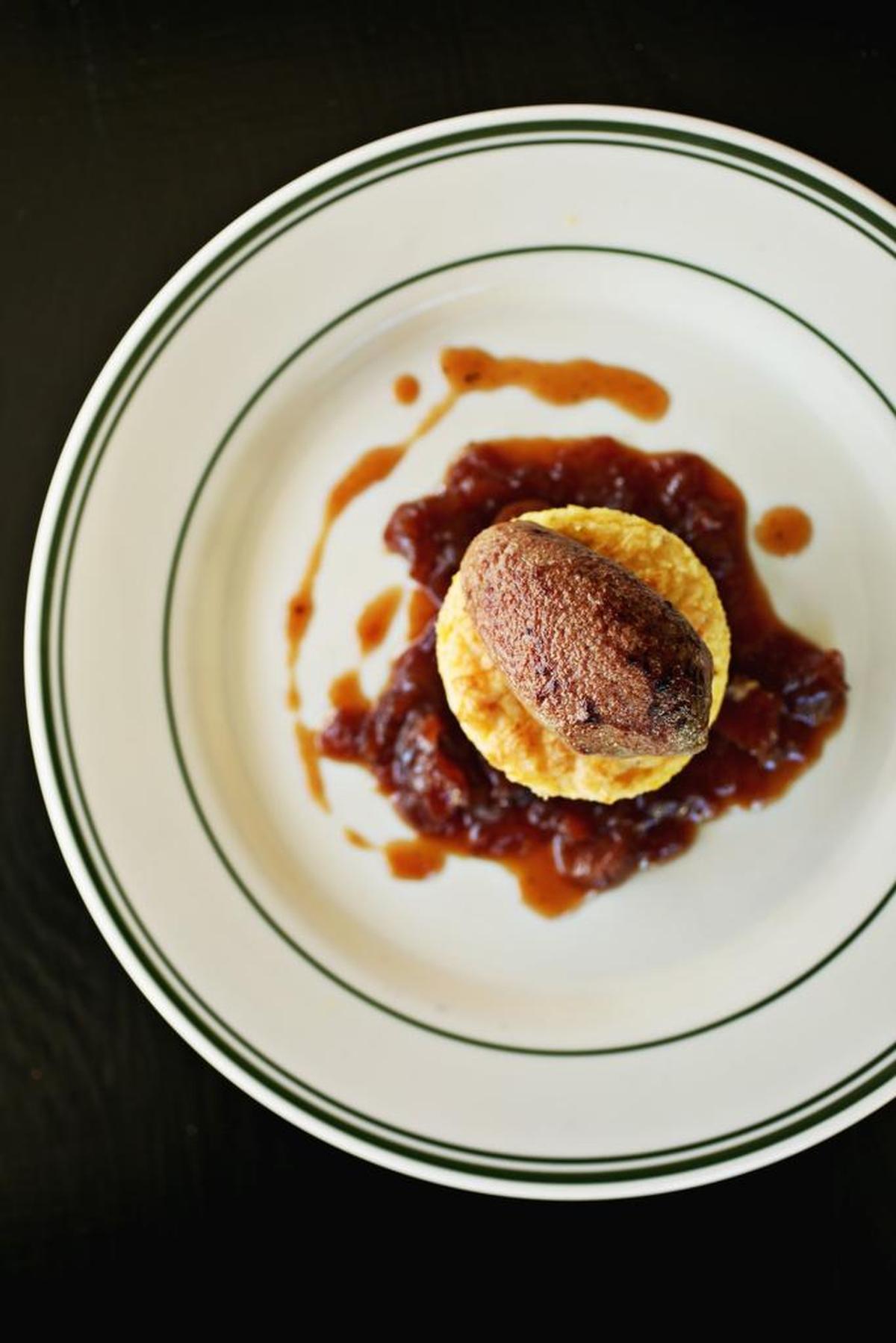 Grits Soufflé with Charred Chicken Liver Mousse, framed in a wreath of earthy-sweet onion jam, has been so popular that it’s pretty much earned a permanent spot on the list of options under the Small Plates heading at The Lakewood in Durham.