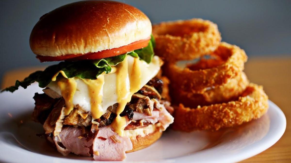 The Benny Bumper Sandwich is served here with onion rings at Just Cookin' in Garner.
