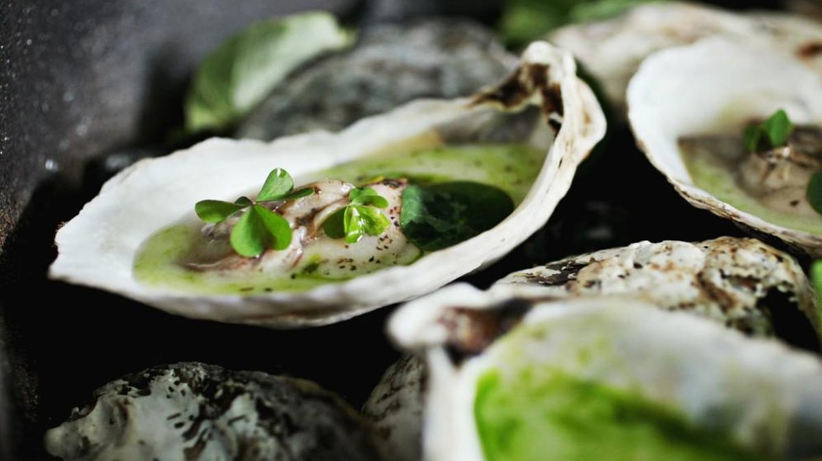 Embered oysters are served at Provenance in a cast iron cocotte lined with oyster shells and smoldering embers, which gently warm the oysters and imbue them with their smoky essence. A garnishing shower of herbs and flower petals put the finishing touch on a truly unforgettable experience for all the senses.