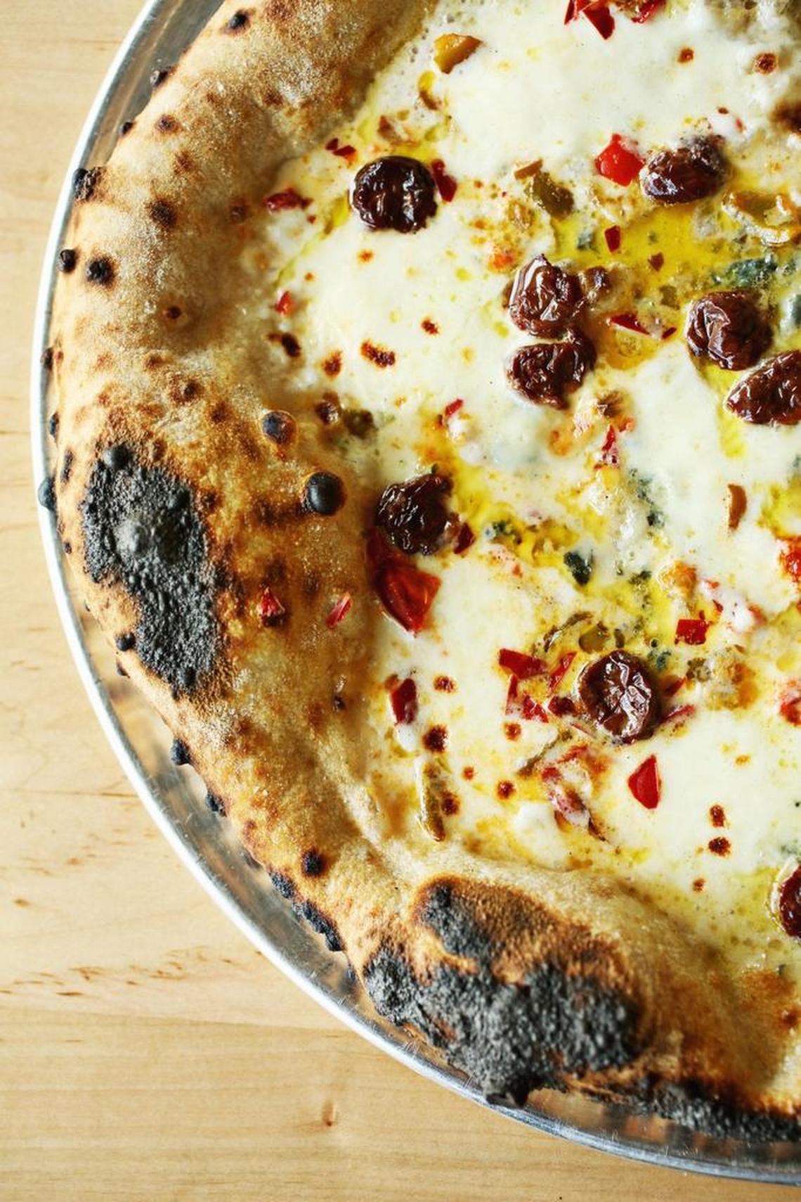 The Red White Blue pizza at Pizzeria Faulisi in Cary is made up of sour cherries, chilis, blue cheese and mozzarella. Toppings are first-rate and carefully applied with a generous hand (but not so generous as to overwhelm the crust).
