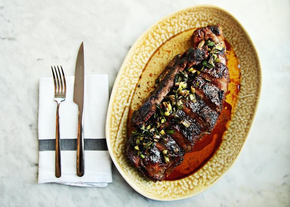 Dry-aged steak, spring onion and chimichurri from the menu at Death & Taxes in downtown Raleigh.