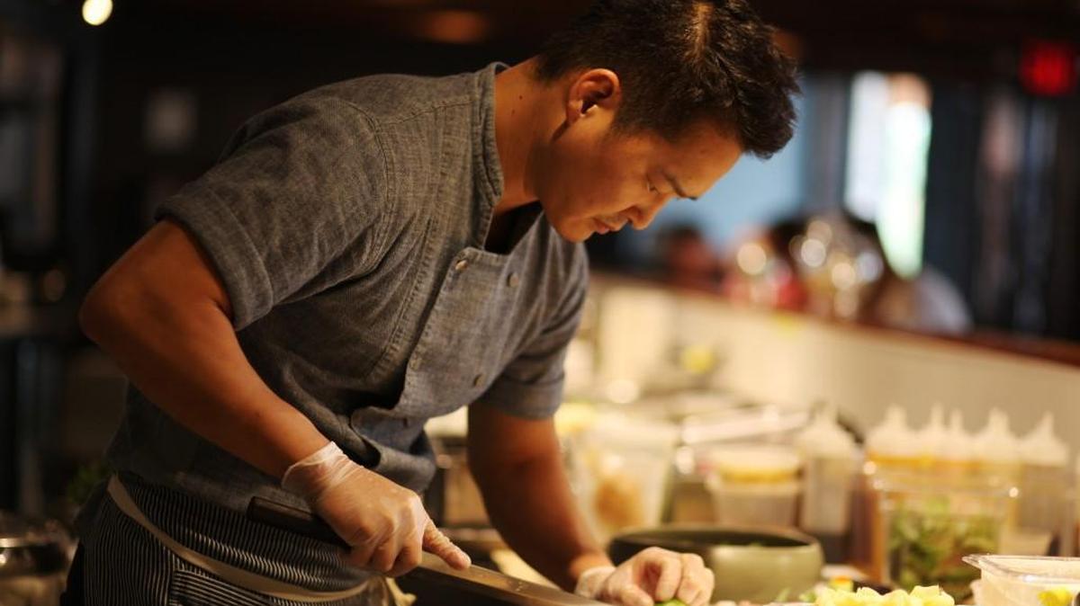 Chef Mike Lee works in the open kitchen of the Durham restaurant M Sushi in 2016. Lee’s vision includes a total of seven restaurant concepts, all within walking distance of each other in downtown Durham.