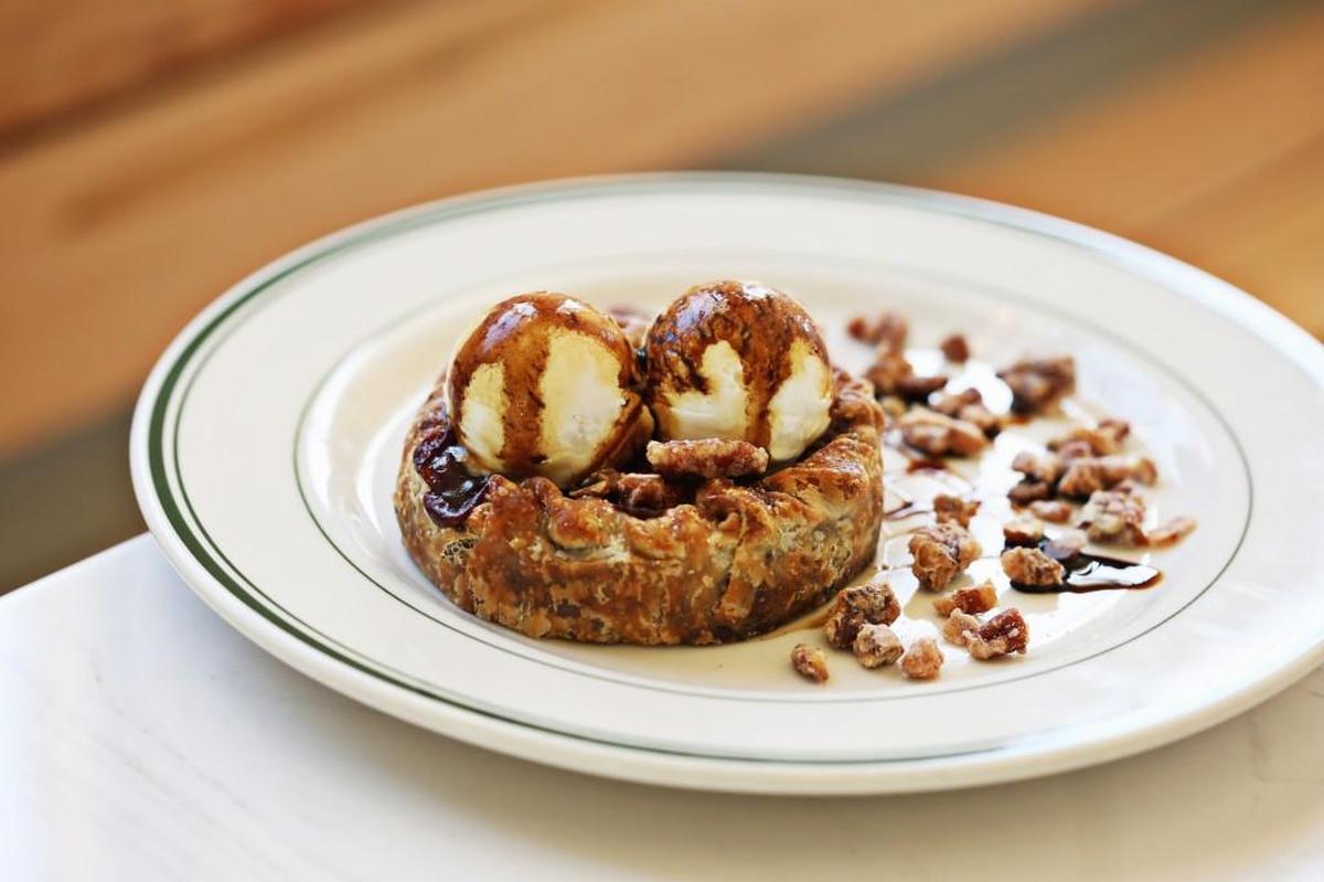 You might find it impossible to resist the siren call of Phoebe Lawless’ Double Crust Muscadine Pie, which she’s serving with a couple of scoops of crème fraîche ice cream on a plate scattered with candied pecans, at The Lakewood in Durham.