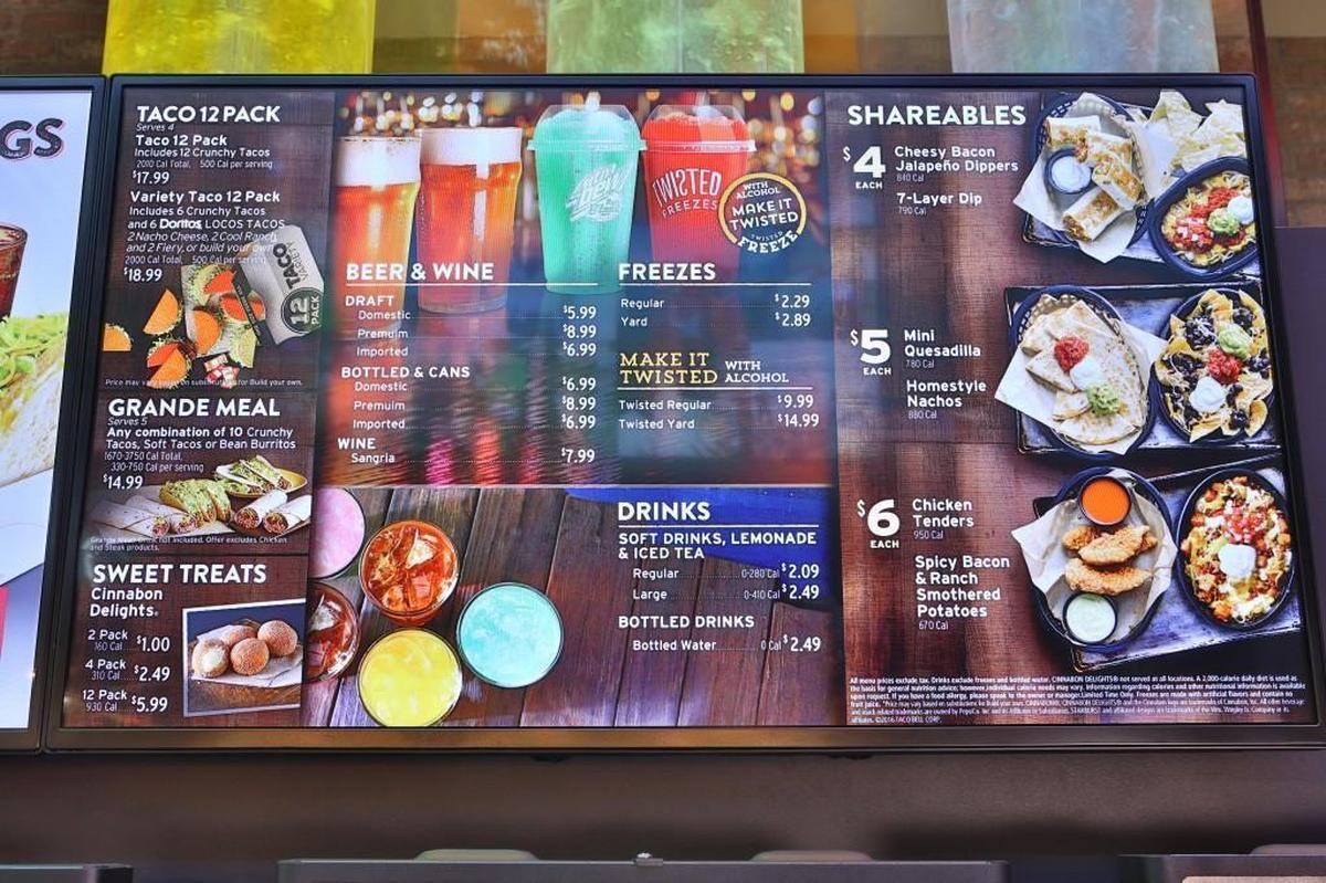 The menu at the Taco Bell flagship in Las Vegas shows a Cantina-style menu: shareable menu items, beer, sangria and alcohol slushies.
