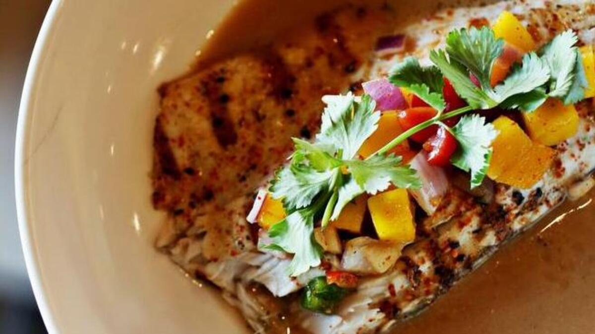 Eighty 8 Asian Bistro, a sleekly stylish purveyor of fusion fare and BOGO sushi that opened in February in Cary, serves a Grilled Barramundi with mango salsa and miso broth.