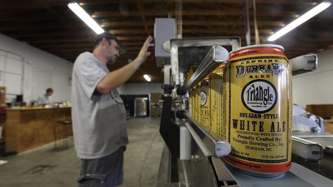 Andy Miller makes a test run of Triangle Brewery's new canning equipment in 2010.