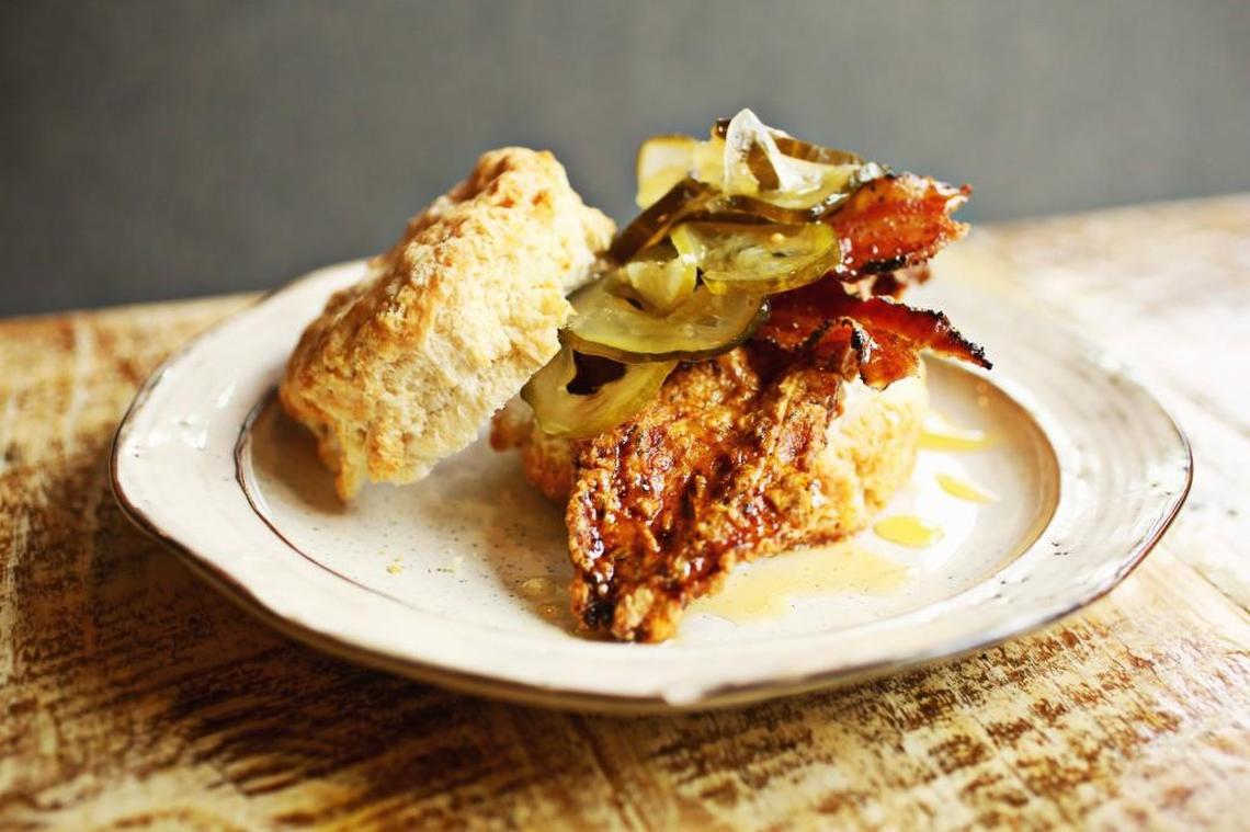 The Best Bird Biscuit is a fried chicken breast with maple pepper bacon topped with Mama's Bred & Butter pickles and a honey butter drizzle served on a buttermilk biscuit at GRUB in Durham.