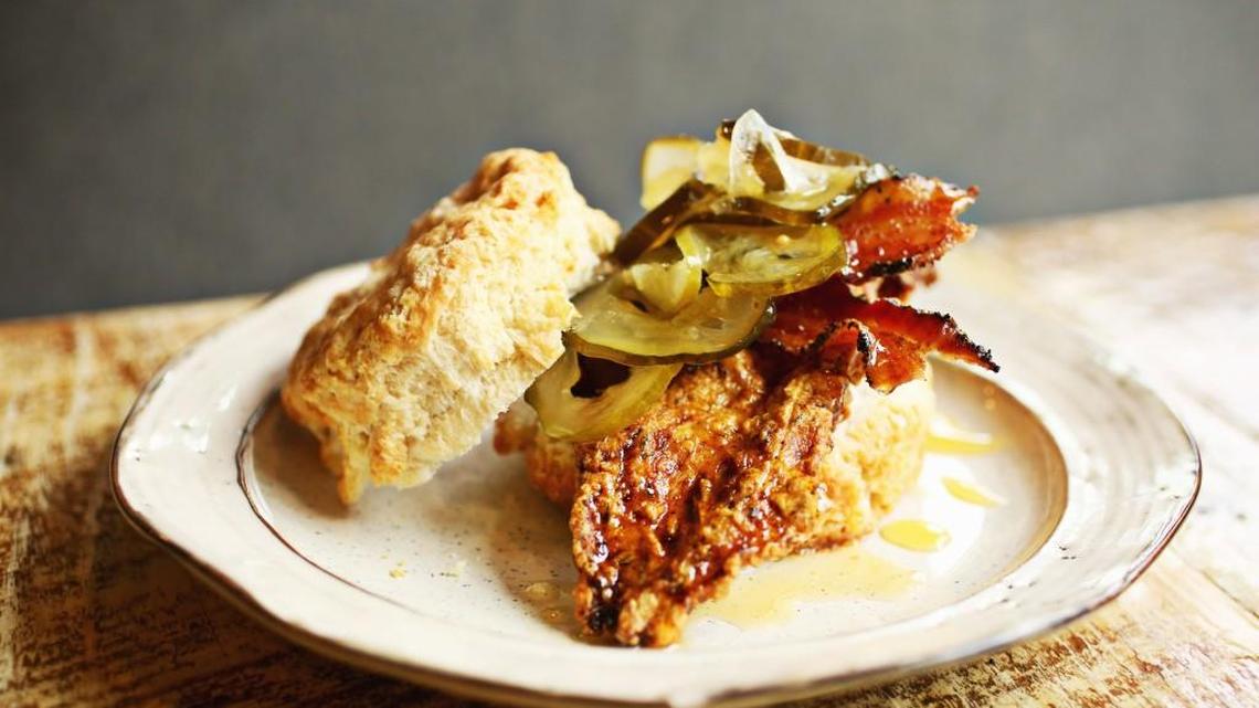 The Best Bird Biscuit is a fried chicken breast with maple pepper bacon topped with Mama's Bred & Butter pickles and a honey butter drizzle served on a buttermilk biscuit at GRUB in Durham.