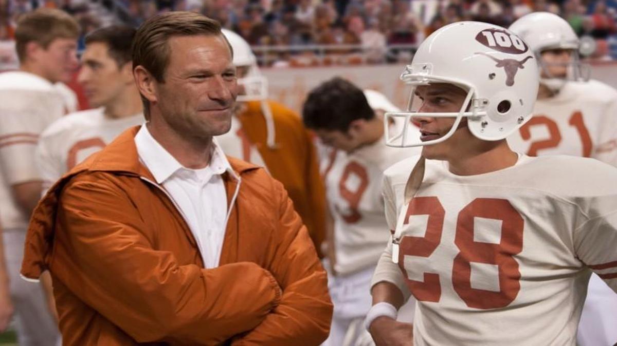 Aaron Eckhart stars as Darrell Royal and Finn Wittrock stars as Freddie Steinmark in Clarius Entertainment's “My All American.”