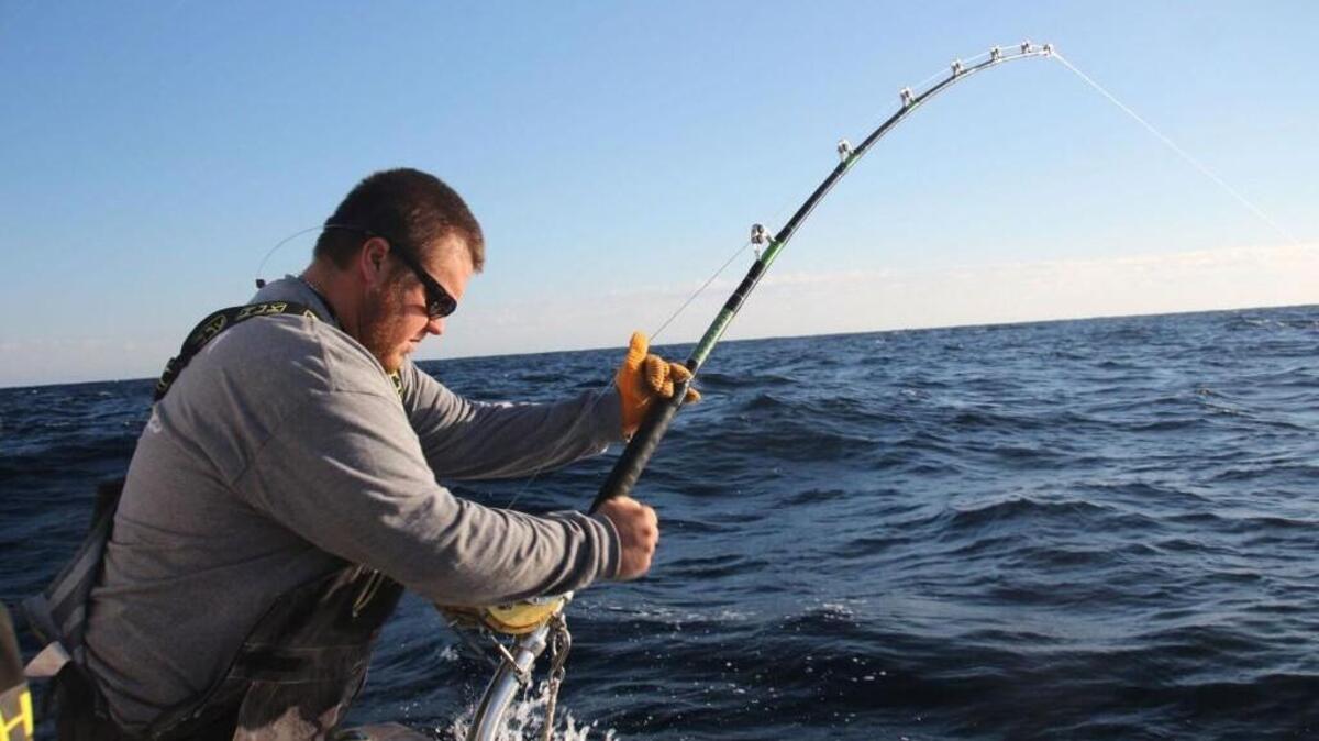 William Hathaway of the boat Foolish Pleasures reeling in a catch off the Outer Banks.