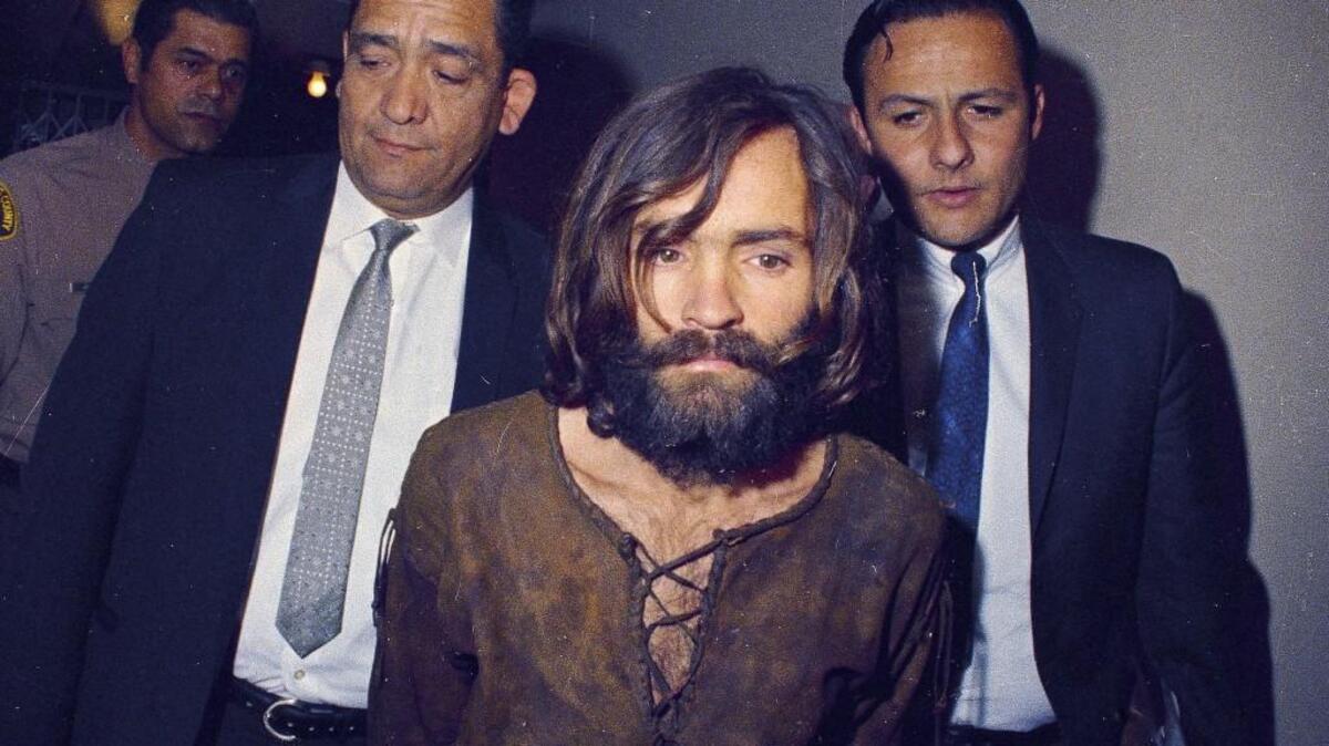 ABC special “Truth and Lies: The Family Manson” looks at the nine 1969 murders carried out by the followers of Charles Manson. In this photo, Manson is escorted to his arraignment on conspiracy-murder charges in connection with the Sharon Tate murder case in 1969 in Los Angeles, Calif.