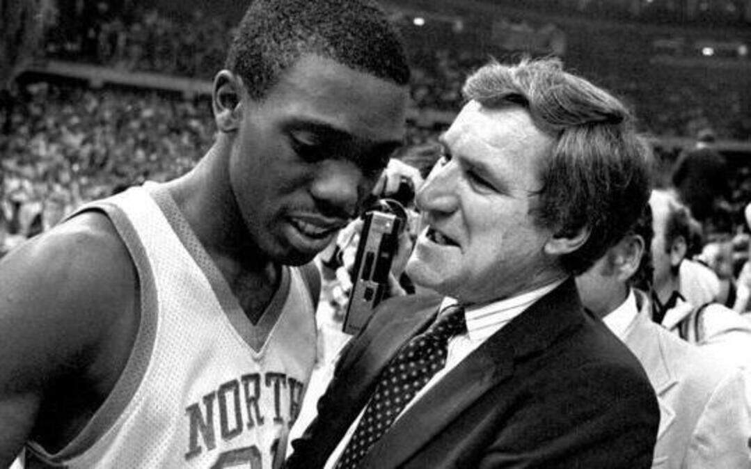 
UNC-Chapel Hill coach Dean Smith congratulates point guard Jimmy Black after the Tar Heels defeated the Georgetown Hoyas to win the 1982 national championship in New Orleans. Even more than his talents as a basketball coach, what stands out about Dean Smith in Showtime’s documentary “Dean Smith,” which debuts Wednesday at 9 p.m., is his humanity and loyalty to his players.

