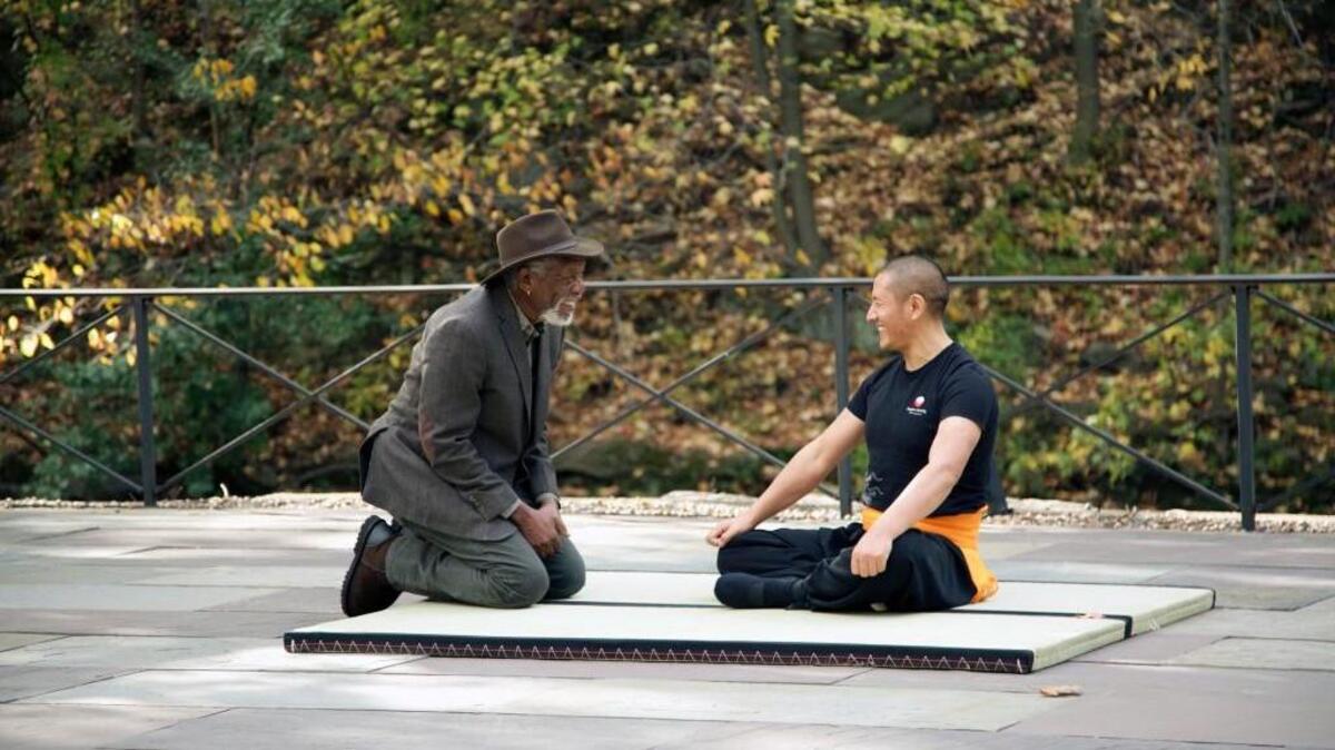 Morgan Freeman, left, interviews Rinpoche Tulku Lobsang, Tibetan Buddhist Tantryana Master, after his brief warm up in the back patio of Minus 5 Icebar on “The Story of God” on the National Geographic Channel.