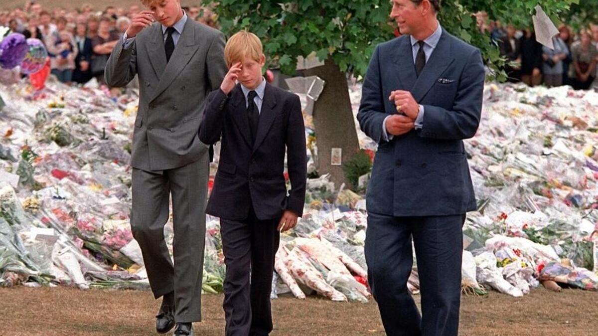 In a file photo from Sept. 5, 1997, Prince Charles, right, accompanies his sons Prince William, left and Prince Harry after they arrived at Kensington Palace to view tributes left in memory of their mother, Princess Diana.