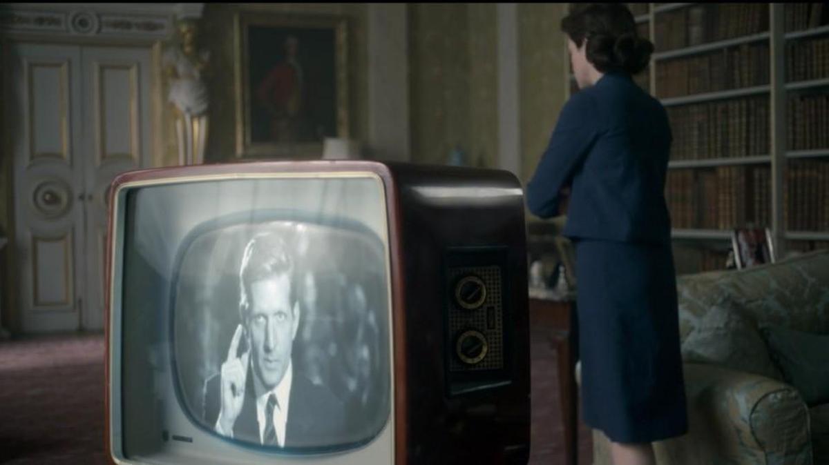 Paul Sparks as Billy Graham on the television, and Claire Foy as Queen Elizabeth in the Netflix series “The Crown.”