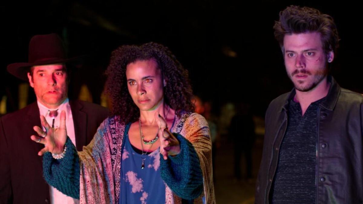 (L-R): Yul Vázquez as Rev. Emilio Sheehan, Parisa Fitz-Henley as Fiji and Francois Arnaud as Manfred in NBC’s “Midnight, Texas.”