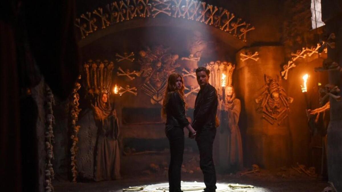 Katherine McNamara and Dominic Sherwood in ABC Family’s “Shadowhunters.”