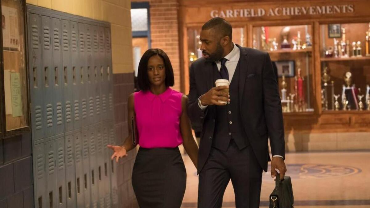 Skye P. Marshall, left, as Ms. Fowdy and Cress Williams as Jefferson Pierce (aka Black Lightning) in the new CW series “Black Lightning.”