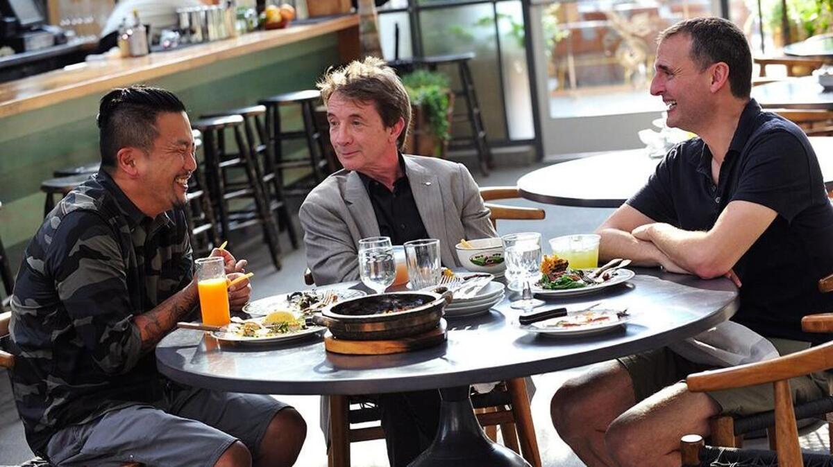 Phil Rosenthal (right) enjoys some of LA’s best Korean food with chef Roy Choi (left) and actor Martin Short (center).