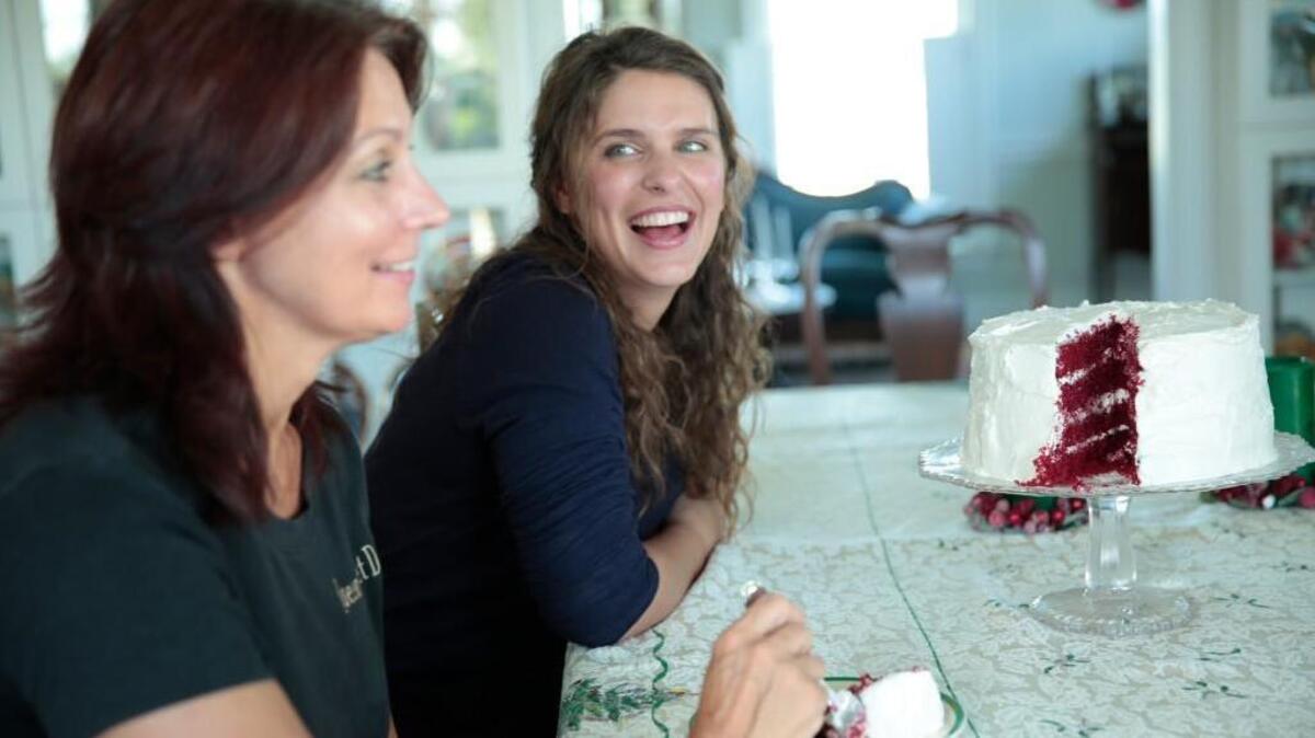 Chef Vivian Howard, right, and her sister Leraine, left, pepare a red velvet cake in the “Chef’s Life Holiday Special.”