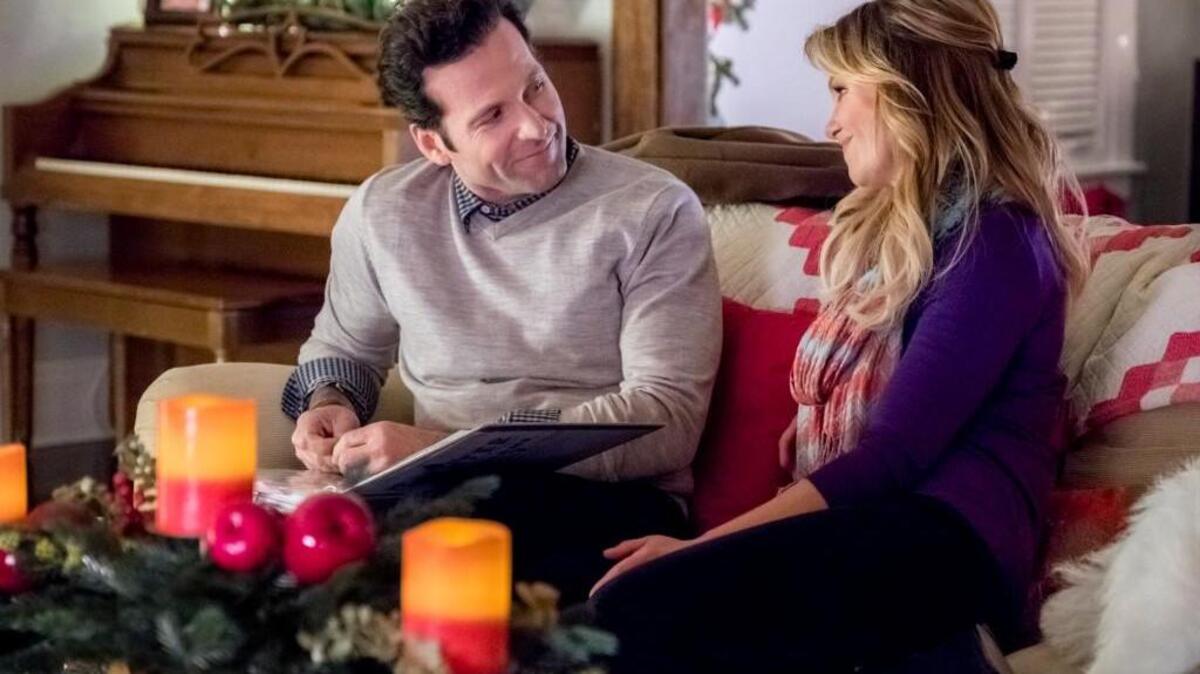 Eion Bailey, left, and Candace Cameron Bure in the Hallmark movie “Switched at Christmas.”