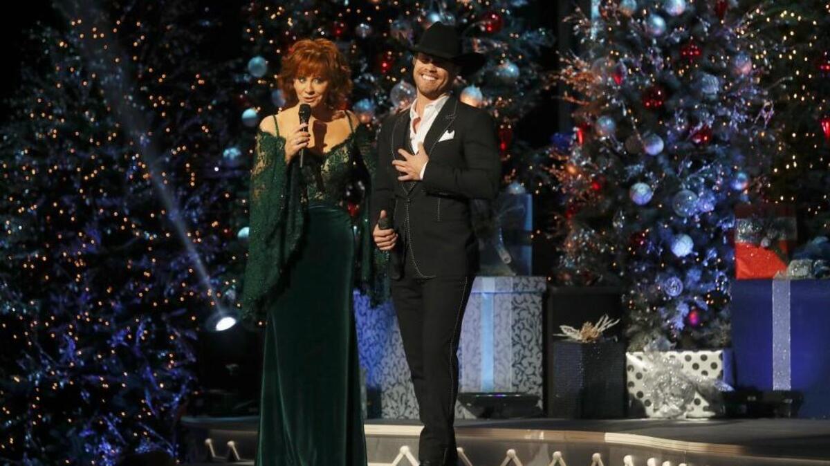 Reba McEntire, left, and Dustin Lynch in the “CMA Country Christmas” special on ABC.