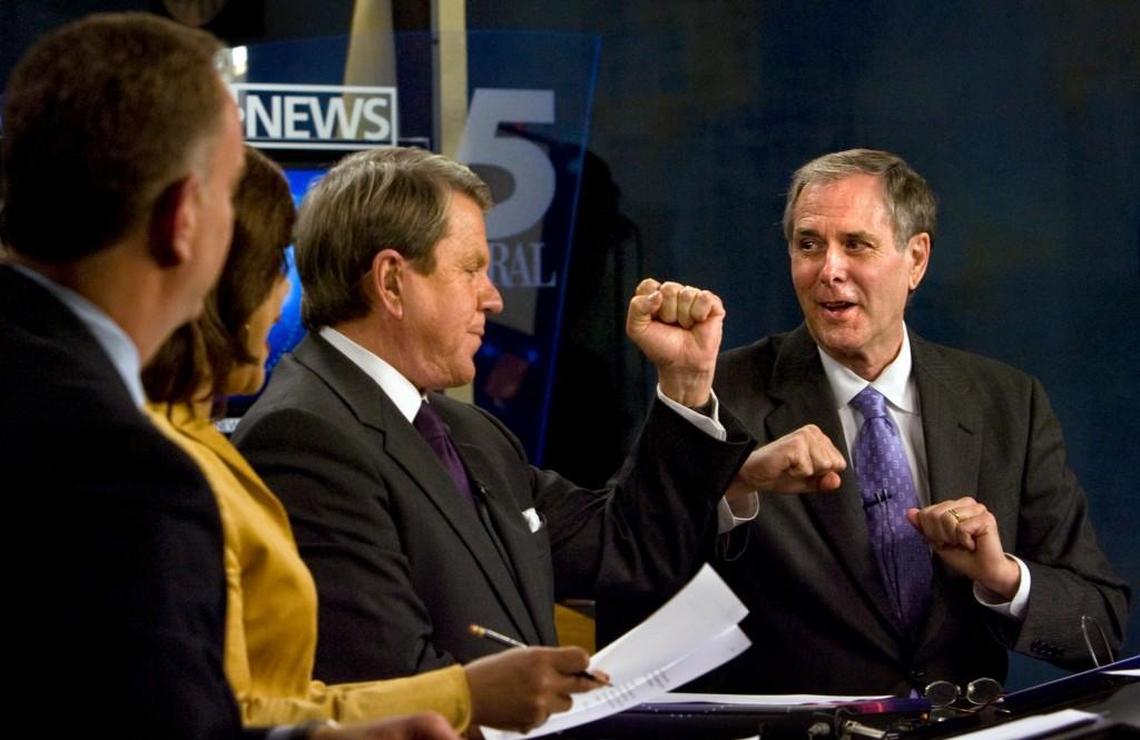 WRAL news anchor David Crabtree, center, “elbow bumps” sports anchor Tom Suiter, right, on Suiter’s last night as a full-time anchor in on Dec. 12, 2008.