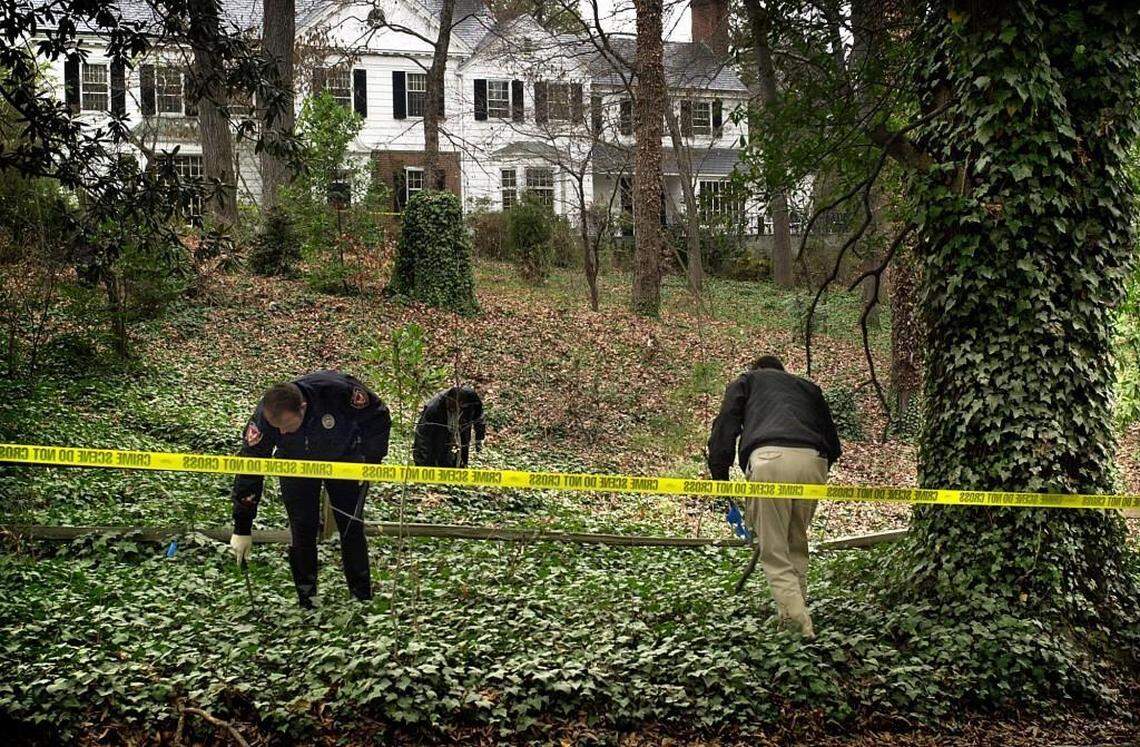 Durham Police officers search for evidence in the front yard of Michael Peterson’s home. Peterson’s wife, Kathleen Hill Peterson, was found dead at the bottom of a staircase in the home on December 10, 2001. Peterson called 911 and said that he believed his wife fell down the stairs after coming inside from the couple’s backyard.