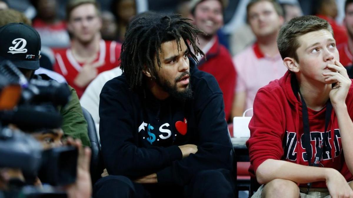 Fayetteville native J. Cole, center, at an N.C. State game in Raleigh on Nov. 11, 2016.