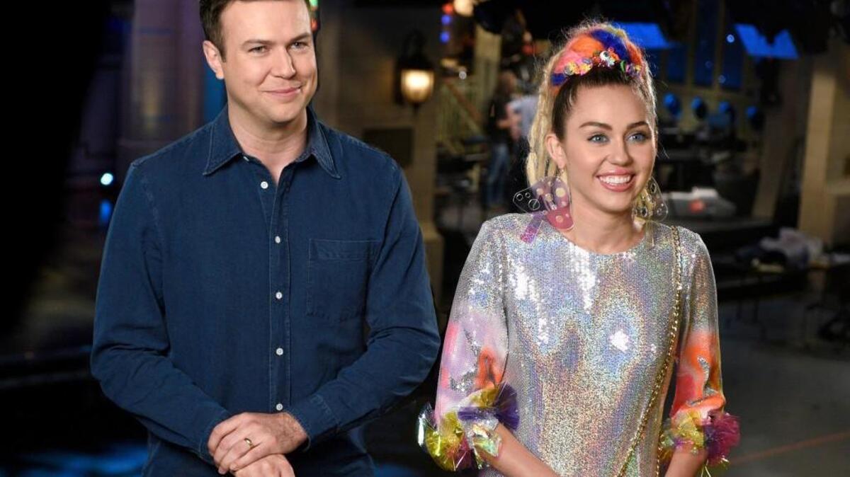 
Taran Killam (left) and host Miley Cyrus promote the new season premiere of “Saturday Night Live.”
