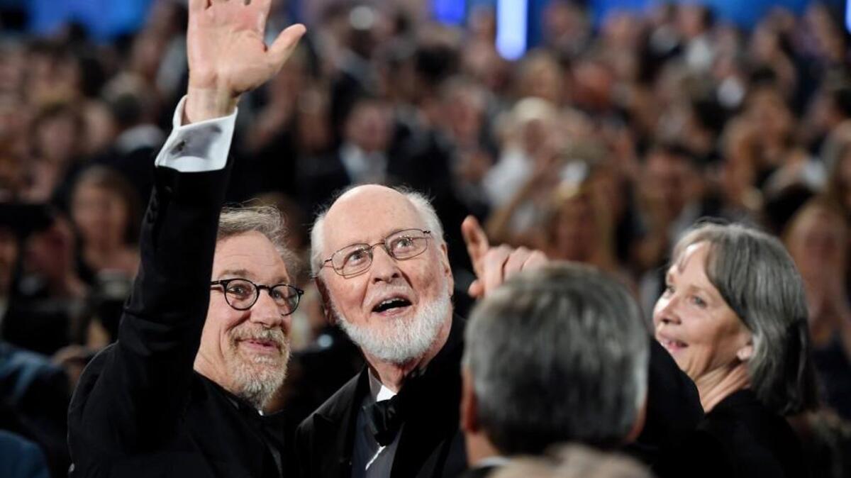Filmmaker Steven Spielberg, left, and composer John Williams wave to the audience during the 2016 AFI Life Achievement Award Gala Tribute to Williams at the Dolby Theatre on June 9 in Los Angeles.