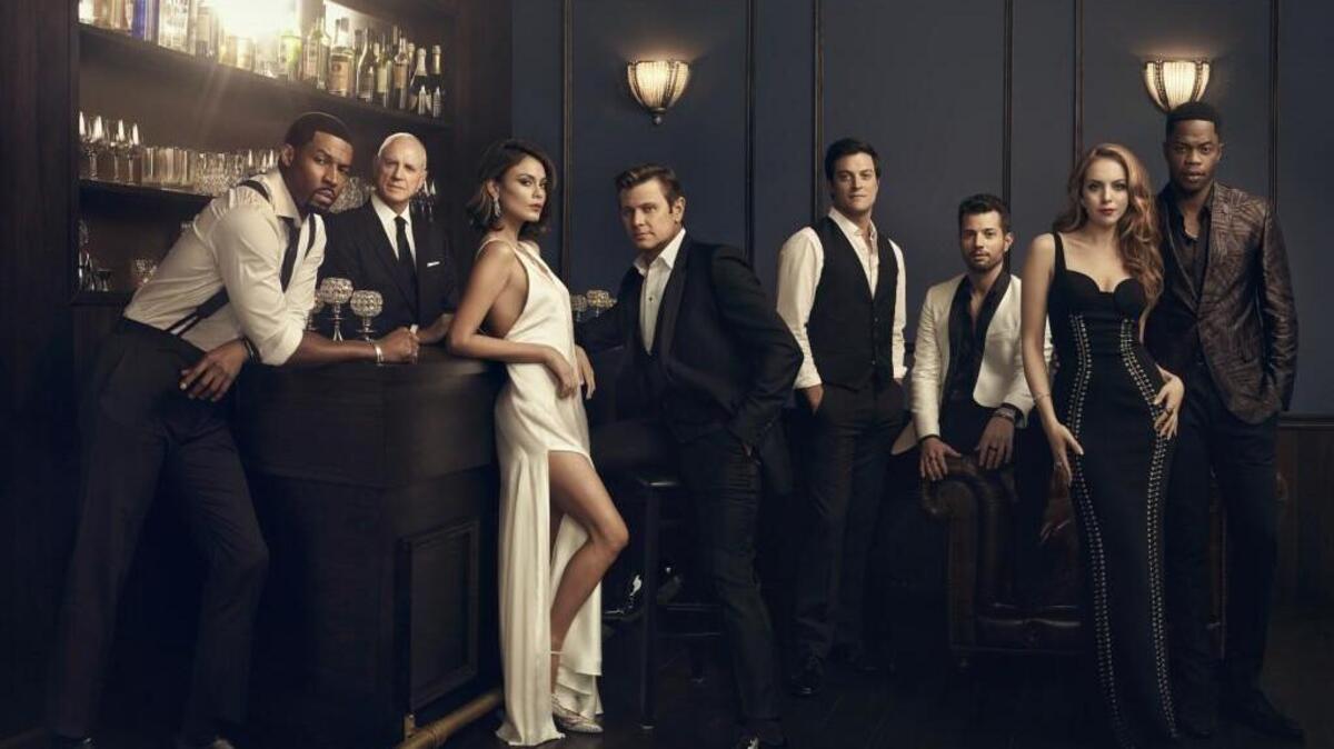 (L-R): Robert Christopher Riley as Michael Culhane, Alan Dale as Joseph Anders, Nathalie Kelley as Cristal Flores, Grant Show as Blake Carrington, James Mackay as Steven Carrington, Rafael de la Fuente as Sam 'Sammy Jo' Flores, Elizabeth Gillies as Fallon Carrington and Sam Adegoke as Jeff Colby.