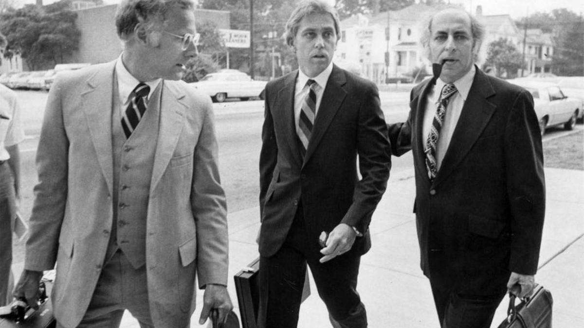 Dr. Jeffery MacDonald, center, arrives at U.S. District Court with attorneys Wade Smith, left, and Bernard Segal, far right, in 1979.