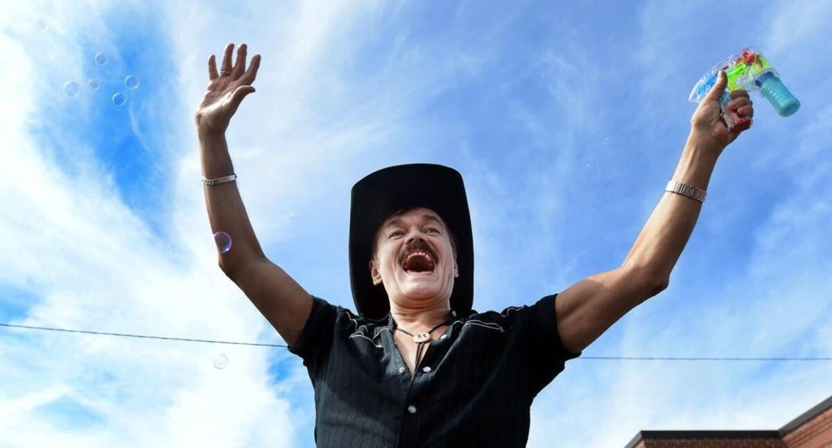 Randy Jones, the original cowboy in the Village People waves to the crowd on Ninth Street in Durham Sept. 27, 2014. The 65-year-old Raleigh native made the Billboard charts for the first time in decades, this time as a solo act, with the single “Hard Times.”