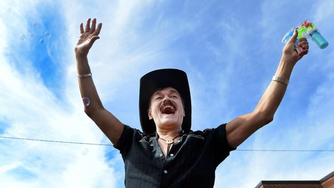 Randy Jones, the original cowboy in the Village People waves to the crowd on Ninth Street in Durham Sept. 27, 2014. The 65-year-old Raleigh native made the Billboard charts for the first time in decades, this time as a solo act, with the single “Hard Times.”