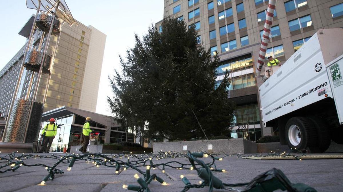 Workers hang lights on the Christmas tree at City Plaza in downtown Raleigh in 2012.