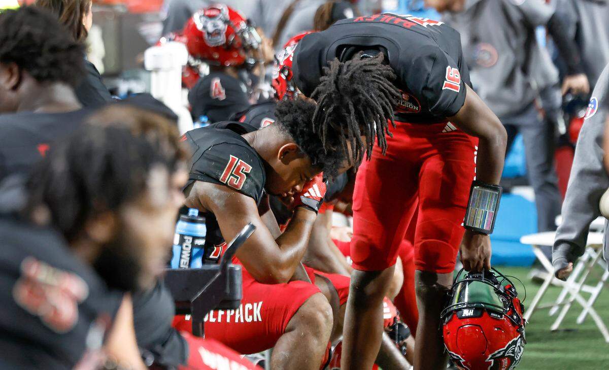 N.C. State quarterback CJ Bailey (16) consoles tight end Justin Joly (15) as time runs out in the game during Duke’s 29-19 victory over N.C. State at Carter-Finley Stadium in Raleigh, N.C., Sat. Nov. 9, 2024.