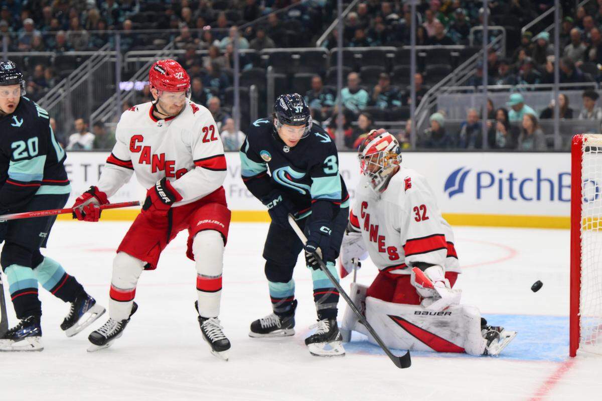 Seattle Kraken center Yanni Gourde (37) scores a goal past Carolina Hurricanes goaltender Antti Raanta (32) during the first period at Climate Pledge Arena on Thursday.
