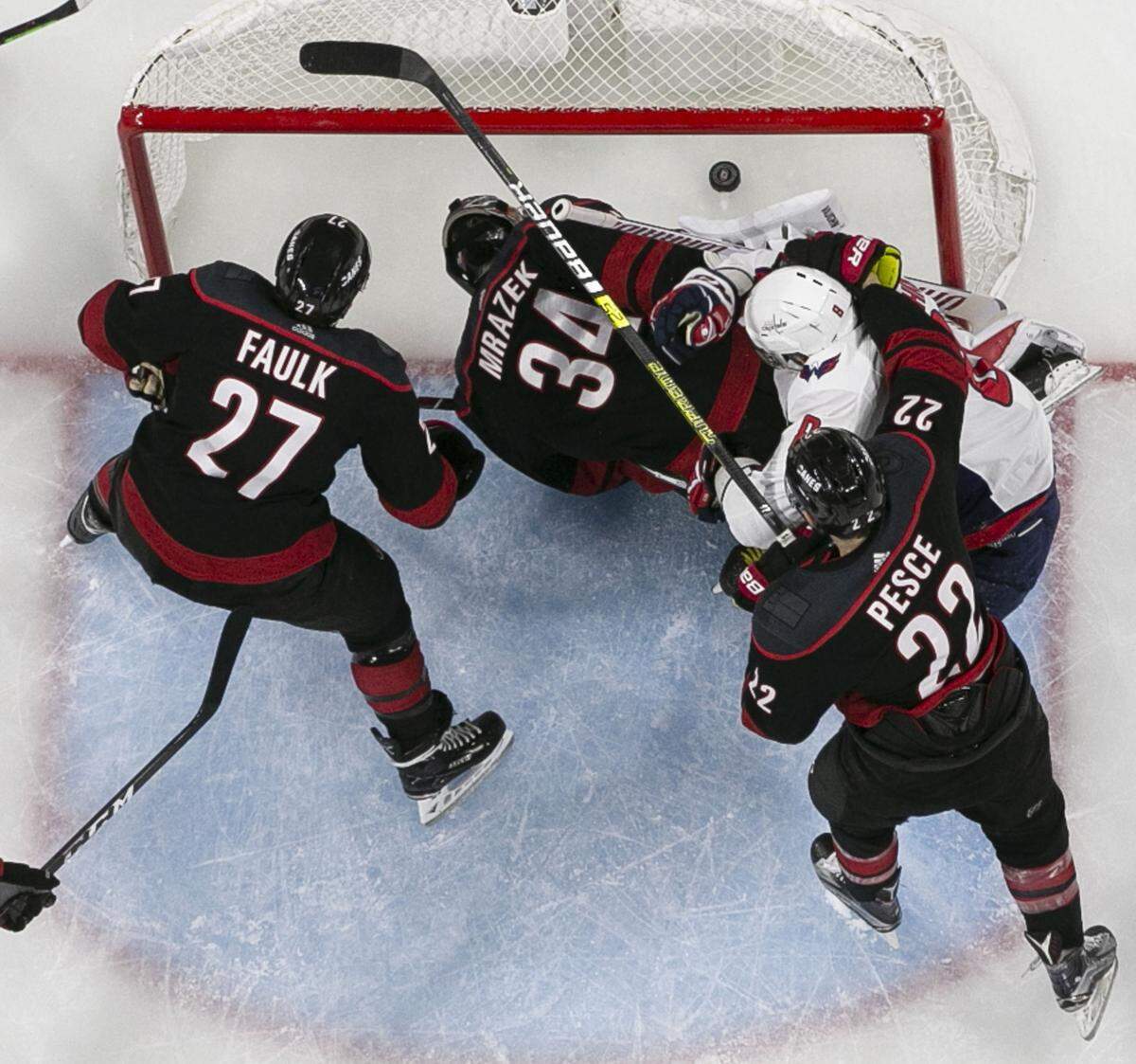 Washington Capitals’ Alex Ovechkin (8) pushes Carolina Hurricanes goalie Petr Mrazek (34) and the puck into the net during the third period in Game 6 of their first round Stanley Cup series on Monday, April 22, 2019 at PNC Arena in Raleigh, N.C. The goal was reviewed and disallowed.