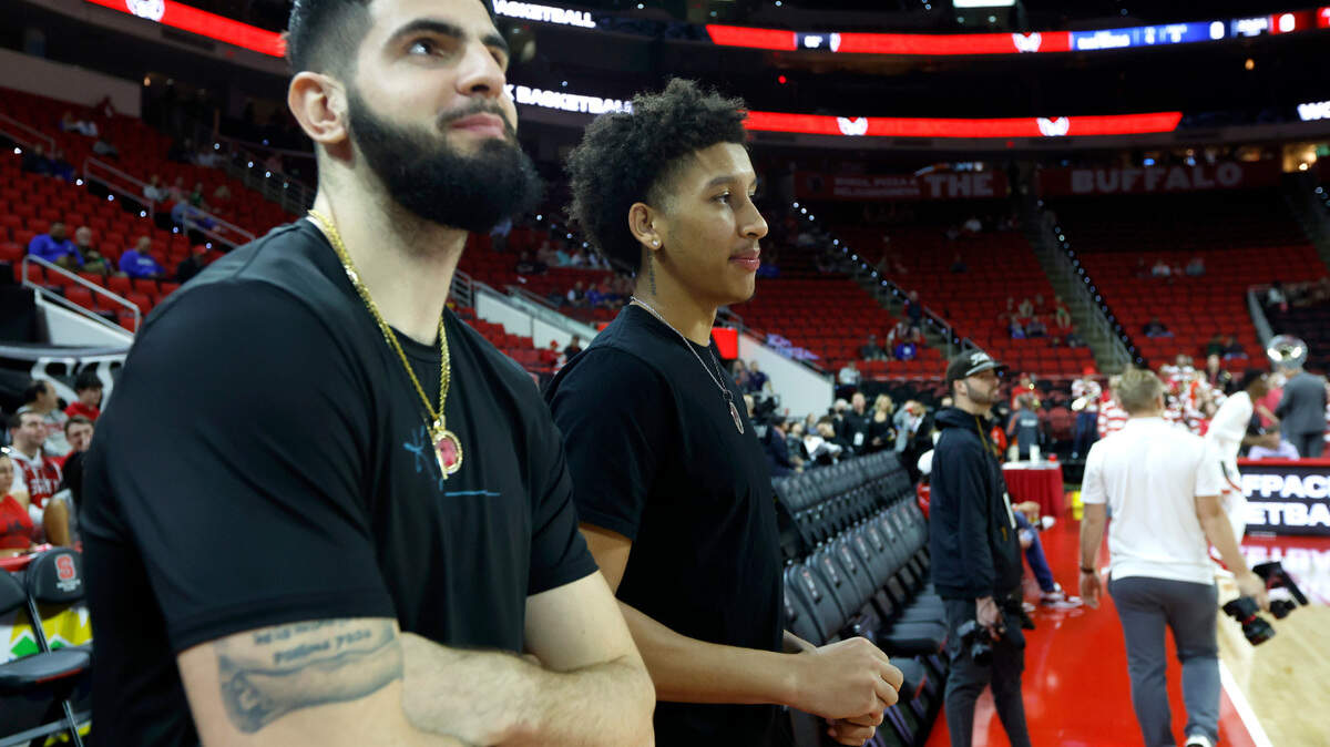 N.C. State’s Jack Clark, right, and Dusan Mahorcic watch the team warmup before N.C. State’s game against Duke at PNC Arena in Raleigh, N.C., Wednesday, Jan. 4, 2023.