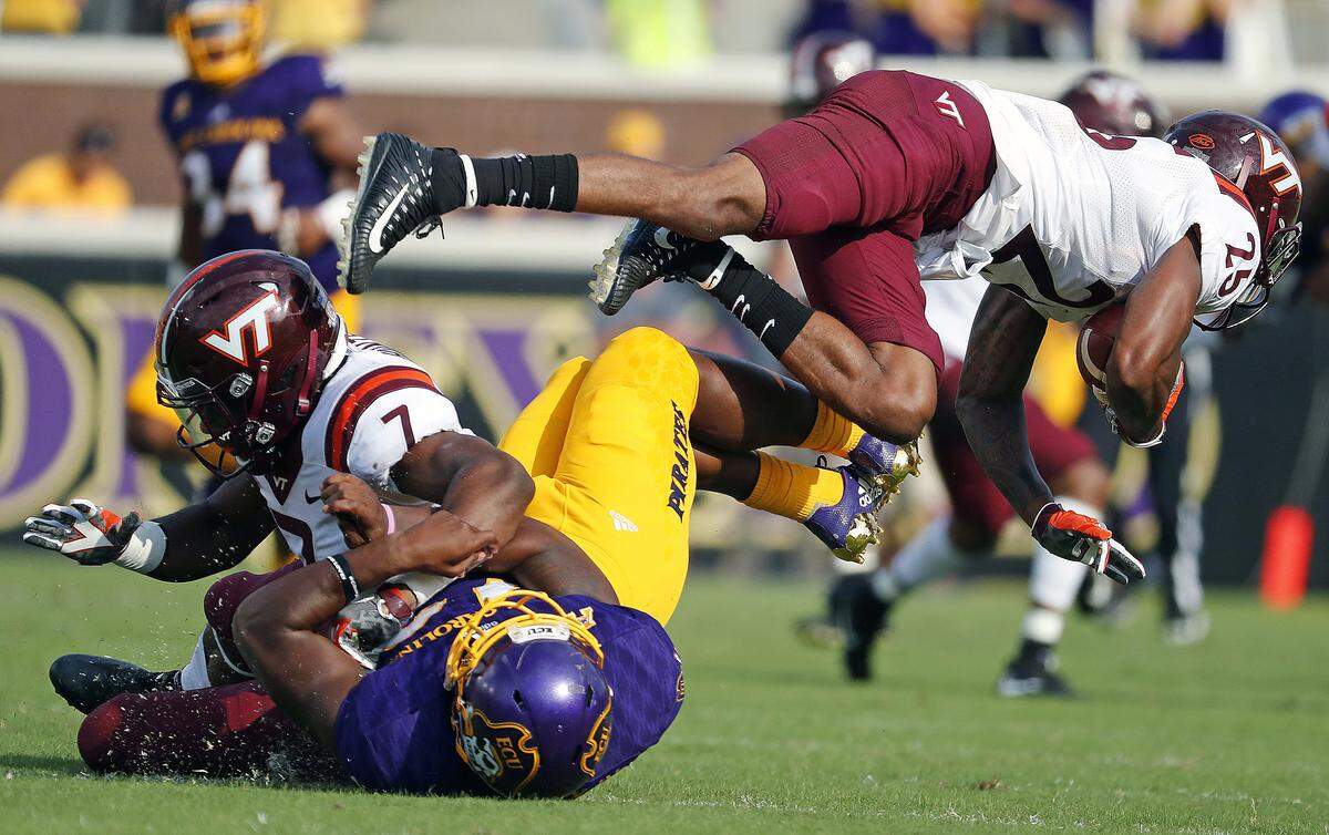 Virginia Tech’s Devon Hunter, top left, collides with East Carolina’s Nate Harvey, bottom, and upends Virginia Tech’s Greg Stroman, right, on Sept. 16, 2017.