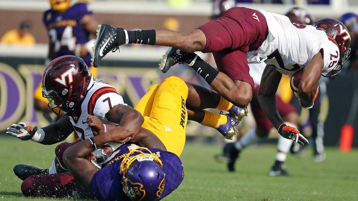 Virginia Tech’s Devon Hunter, top left, collides with East Carolina’s Nate Harvey, bottom, and upends Virginia Tech’s Greg Stroman, right, on Sept. 16, 2017.