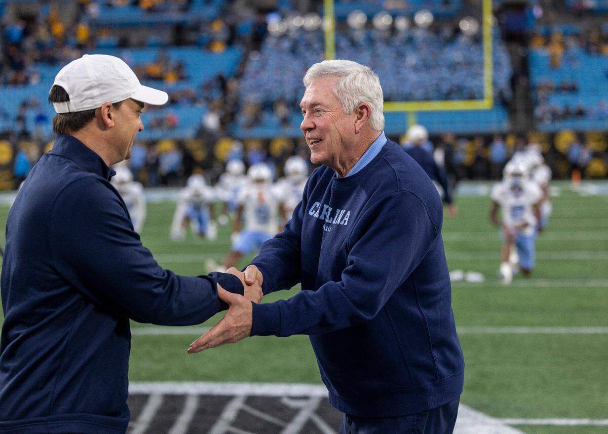 North Carolina coach Mack Brown shakes hands with West Virginia coach Neal Brown prior to their game in the Duke’s Mayo Bowl on Wednesday, December 27, 2023 at Bank of American Stadium in Charlotte, N.C.