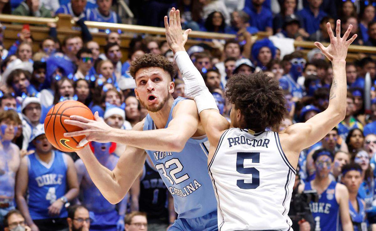 North Carolina’s Pete Nance (32) looks for room as Duke’s Tyrese Proctor (5) defends during the first half of Duke’s game against UNC at Cameron Indoor Stadium in Durham, N.C., Saturday, Feb. 4, 2023.